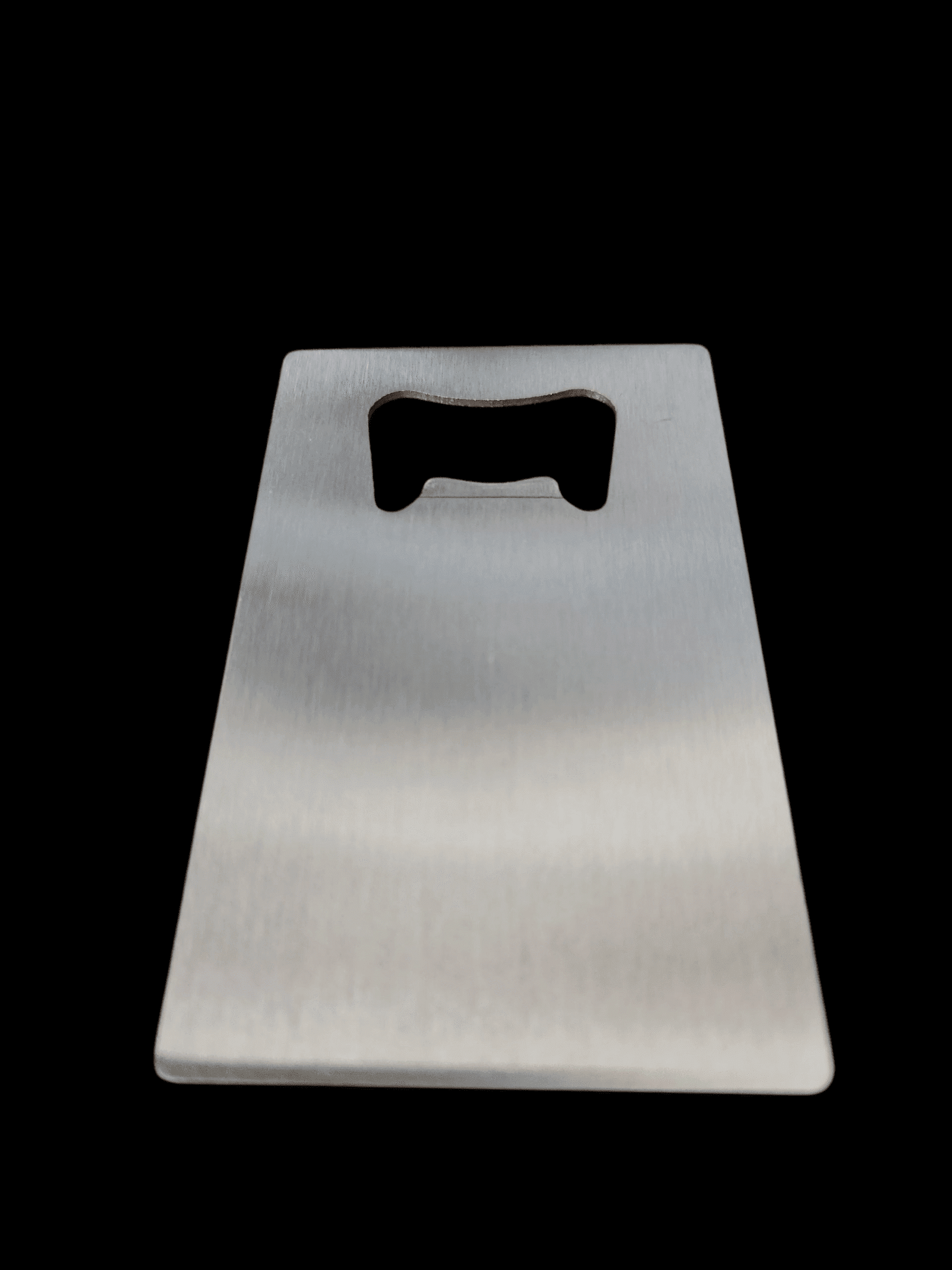 A metallic bottle opener with a simple rectangular design.