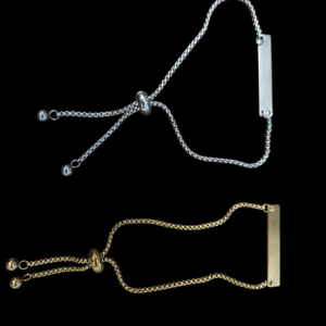 Two adjustable chain bracelets, one silver and one gold, each with a bar accent.