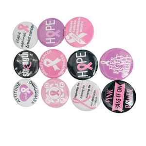 Collection of breast cancer awareness pins with pink ribbons and hopeful messages.