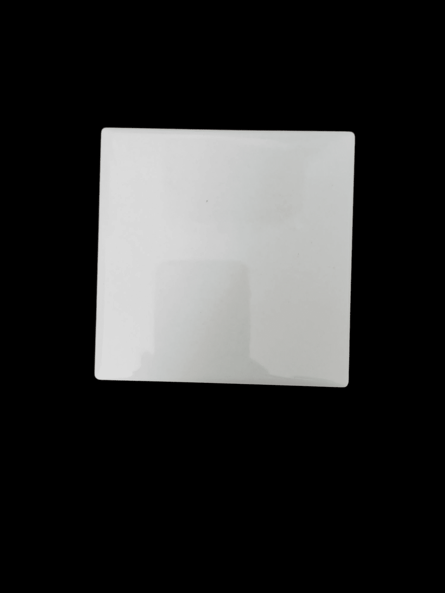 A white square tile with slight shadowing on a black background.