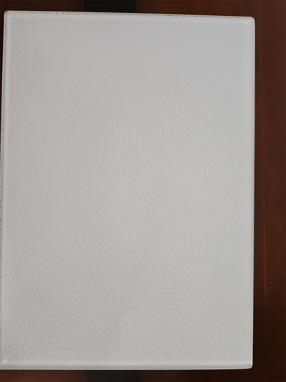 Blank white paper on a wooden surface.