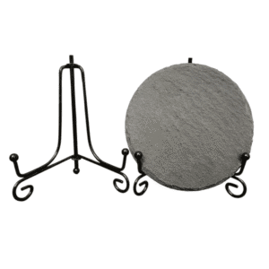 Two black metal display stands, one holding a round textured plate.