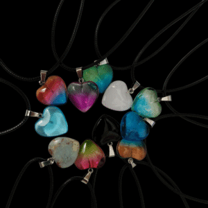 Colorful heart-shaped pendants on black cords.