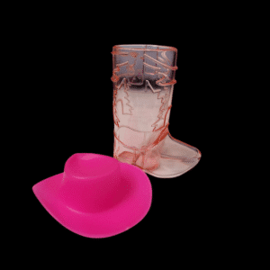 A pink cowboy hat and a transparent cowboy boot with pink accents on a black background.