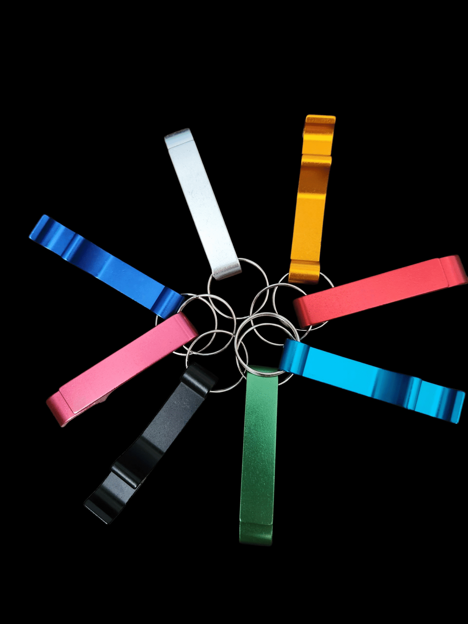 Colorful keychains arranged in a circle on a black background.