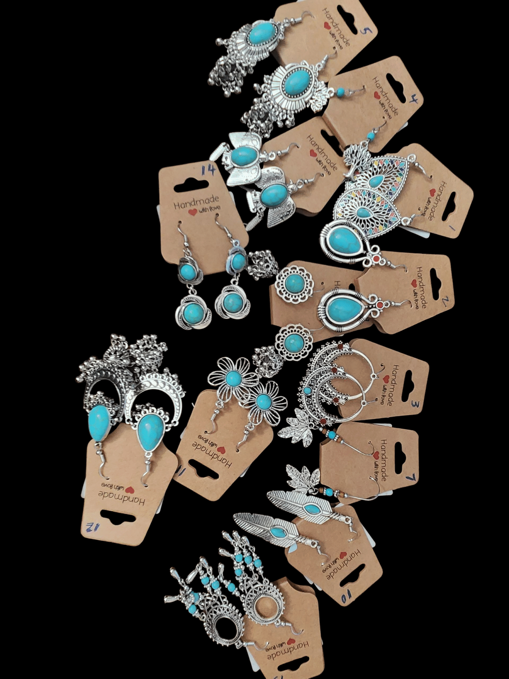 A display of turquoise and silver jewelry sets with earrings and pendants.