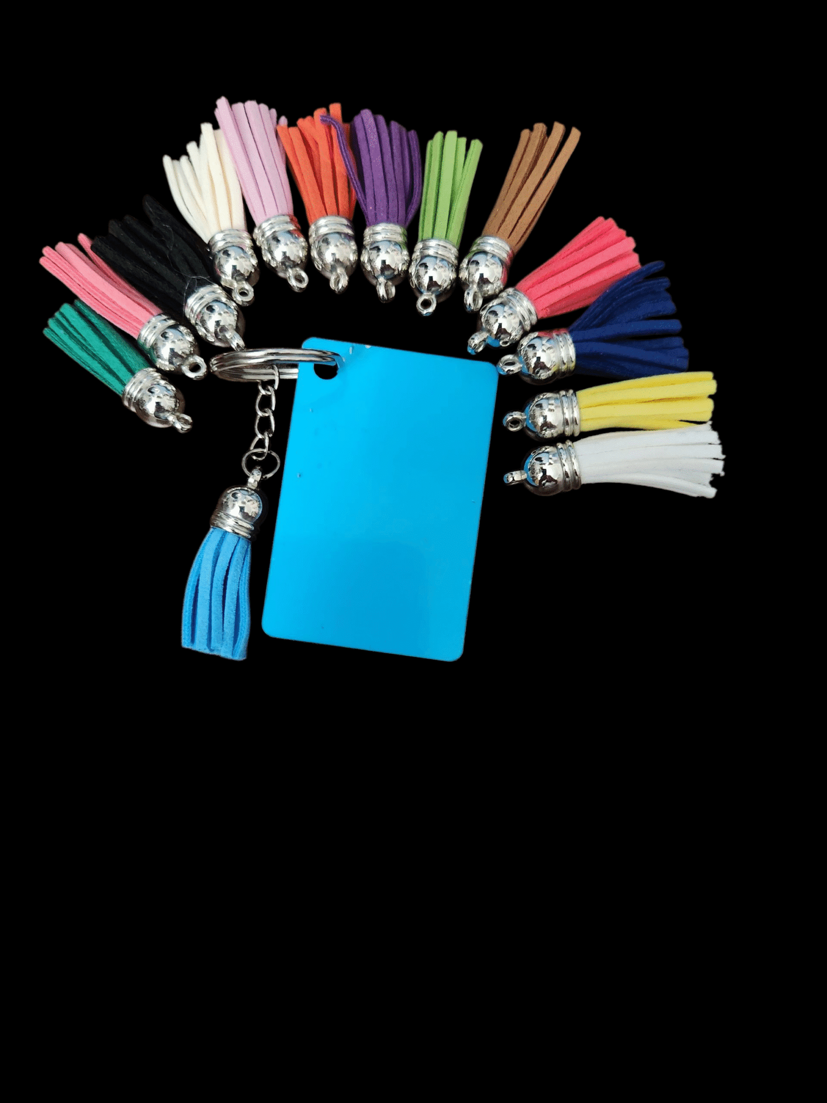 Colorful tassels arranged in a semicircle with a blue card and one tassel in the center.