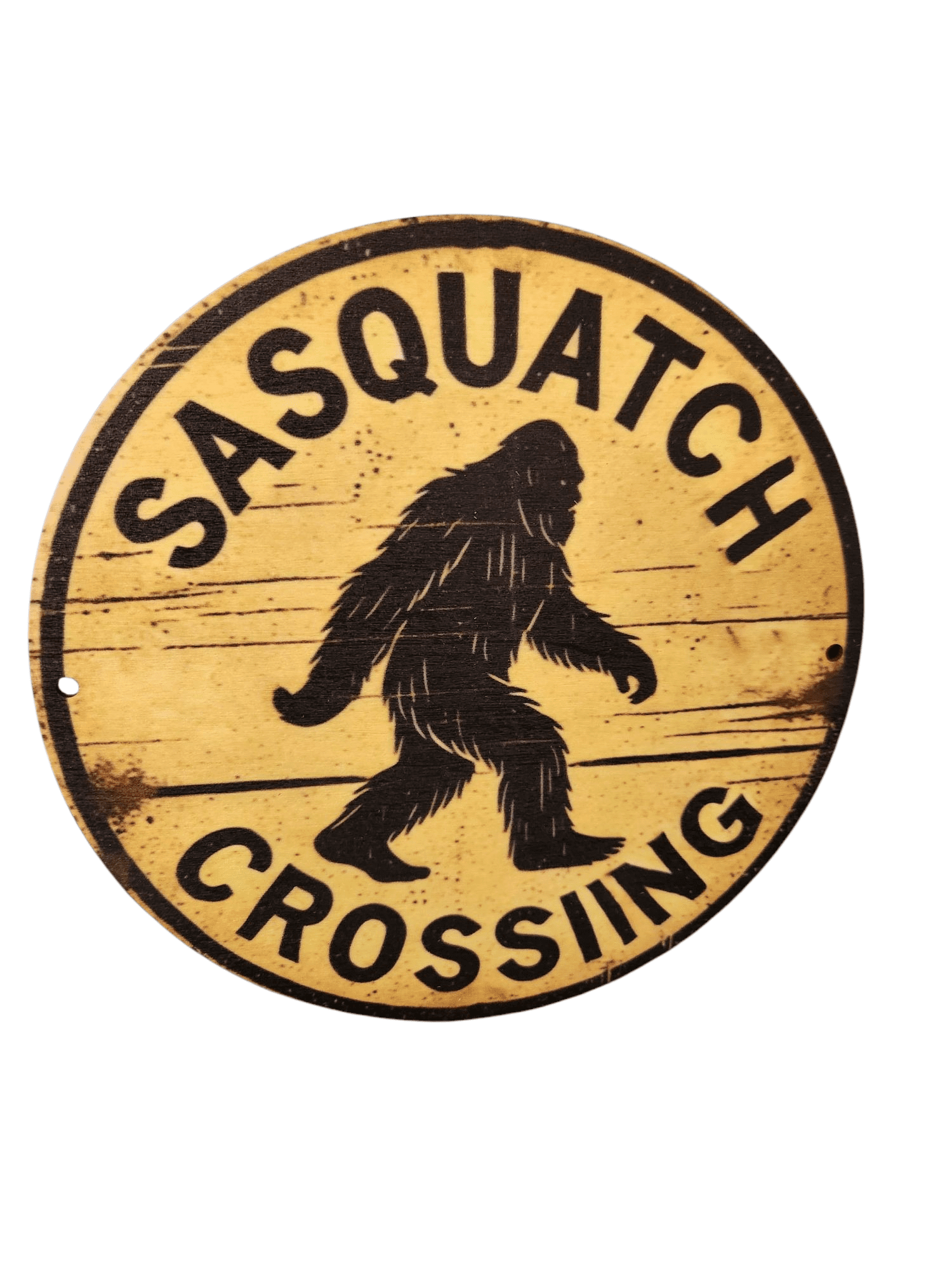 Round wooden sign with Sasquatch crossing warning and bigfoot silhouette.