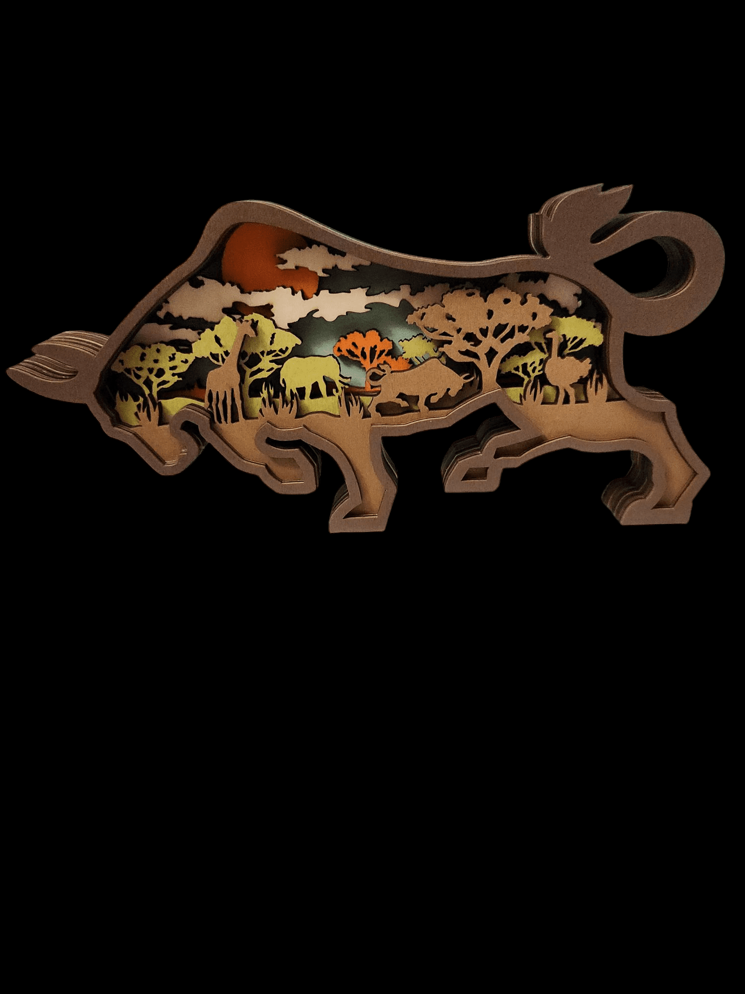 Stylized bull silhouette filled with a desert wildlife scene at sunset.
