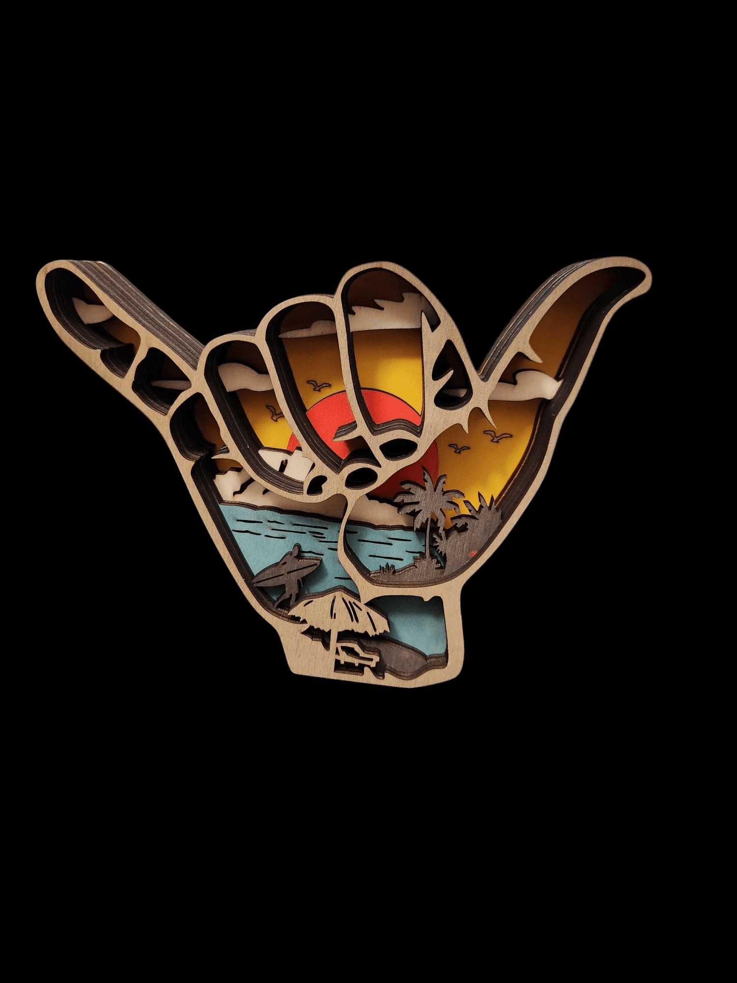 A colorful wooden hand making a shaka sign with beach imagery.