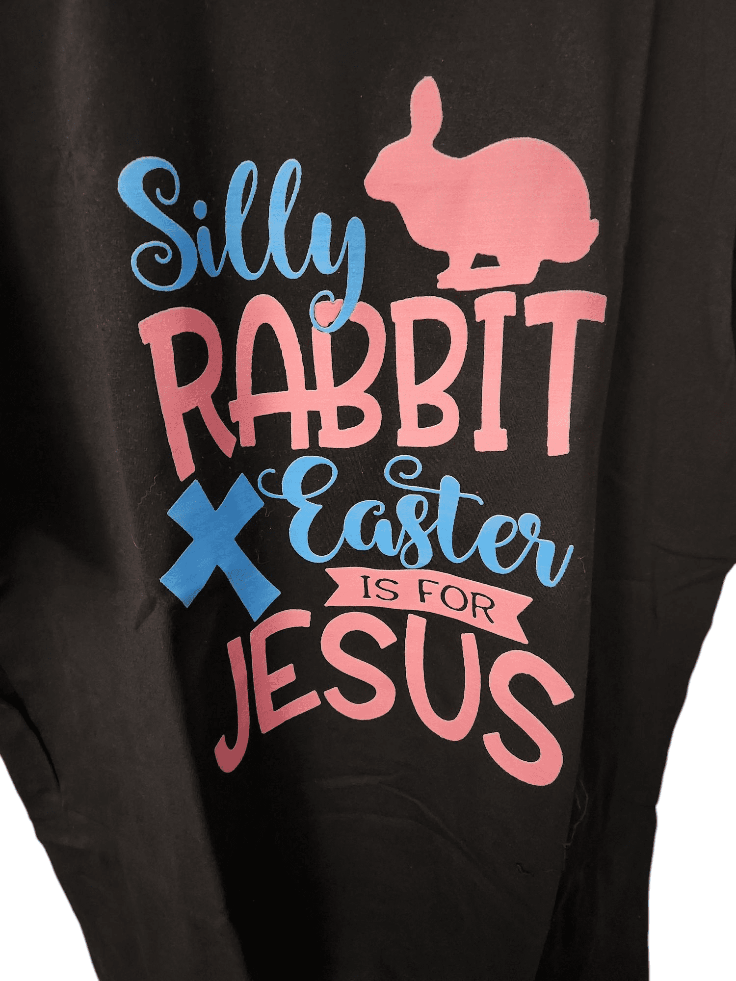 Colorful Easter-themed text with a rabbit silhouette on black fabric.