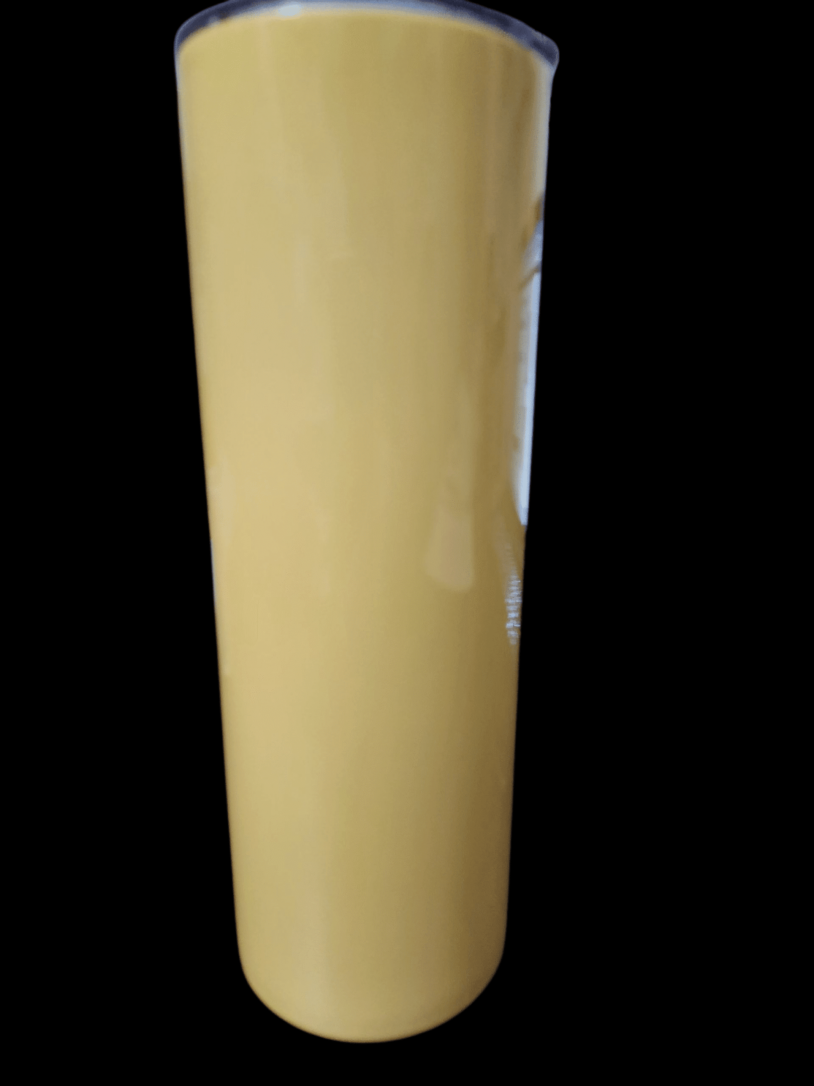 Tall glass of creamy mango smoothie with a smooth texture.