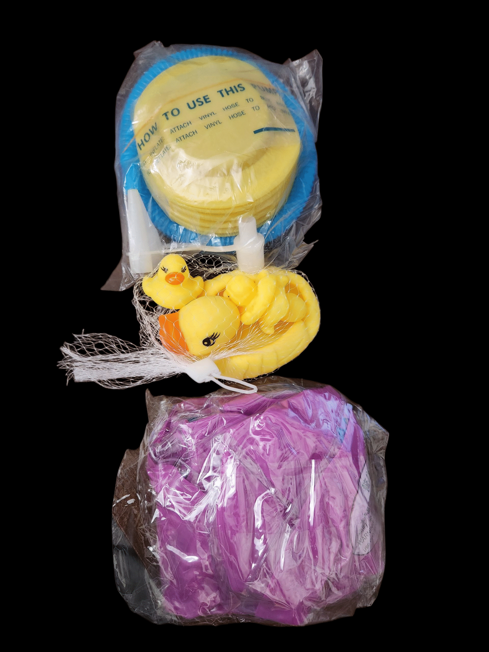 A set of bath items including a yellow soap, a yellow sponge, and a purple towel.