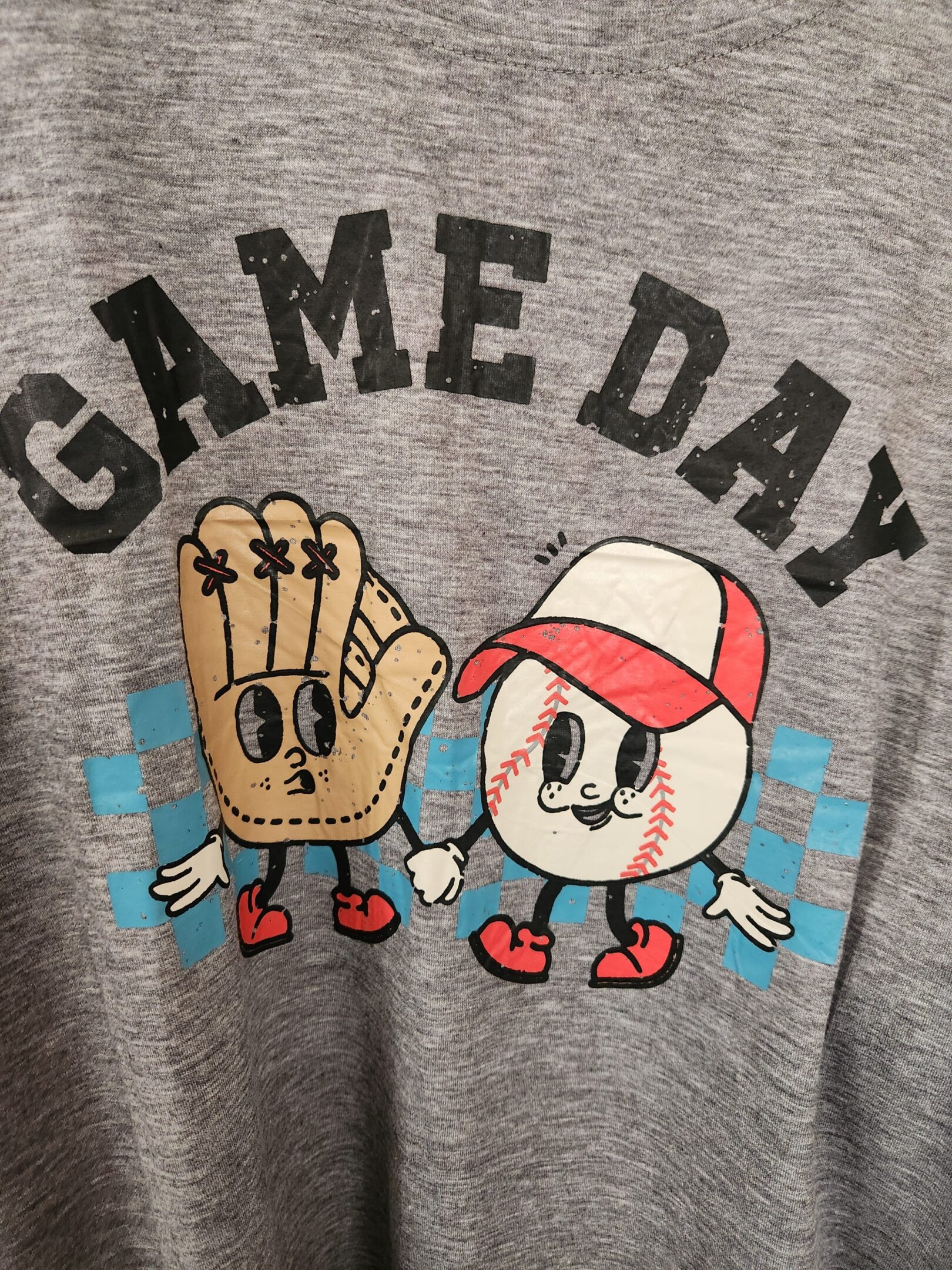 Cartoon baseball glove and ball characters with 'GAME DAY' text on a gray shirt.