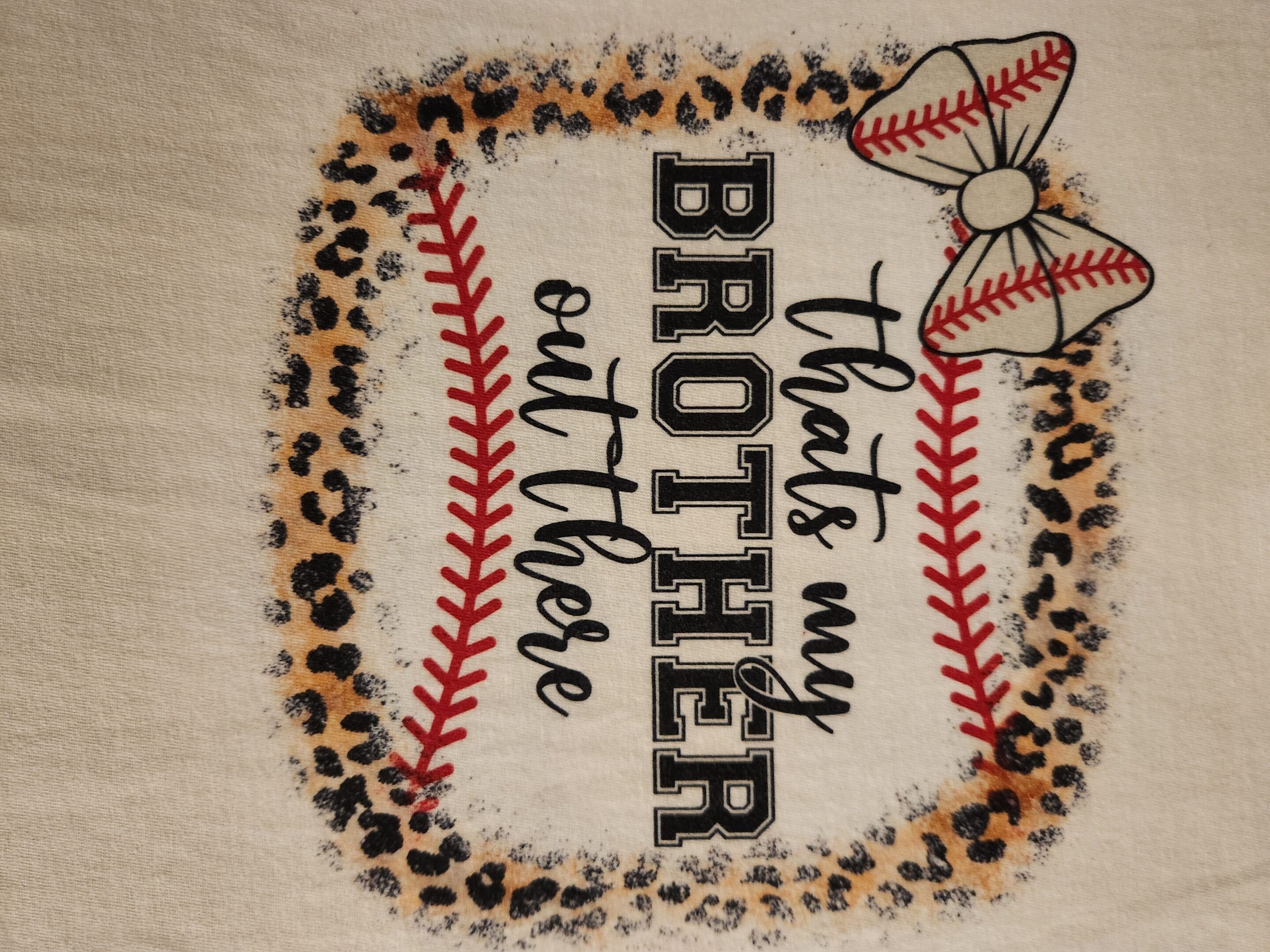 A baseball-themed design with leopard print and the phrase 'That's my brother on the field' embroidered.