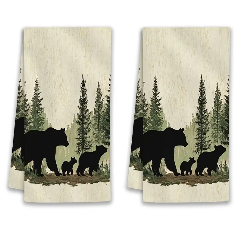 Two towels with bear and pine tree designs.