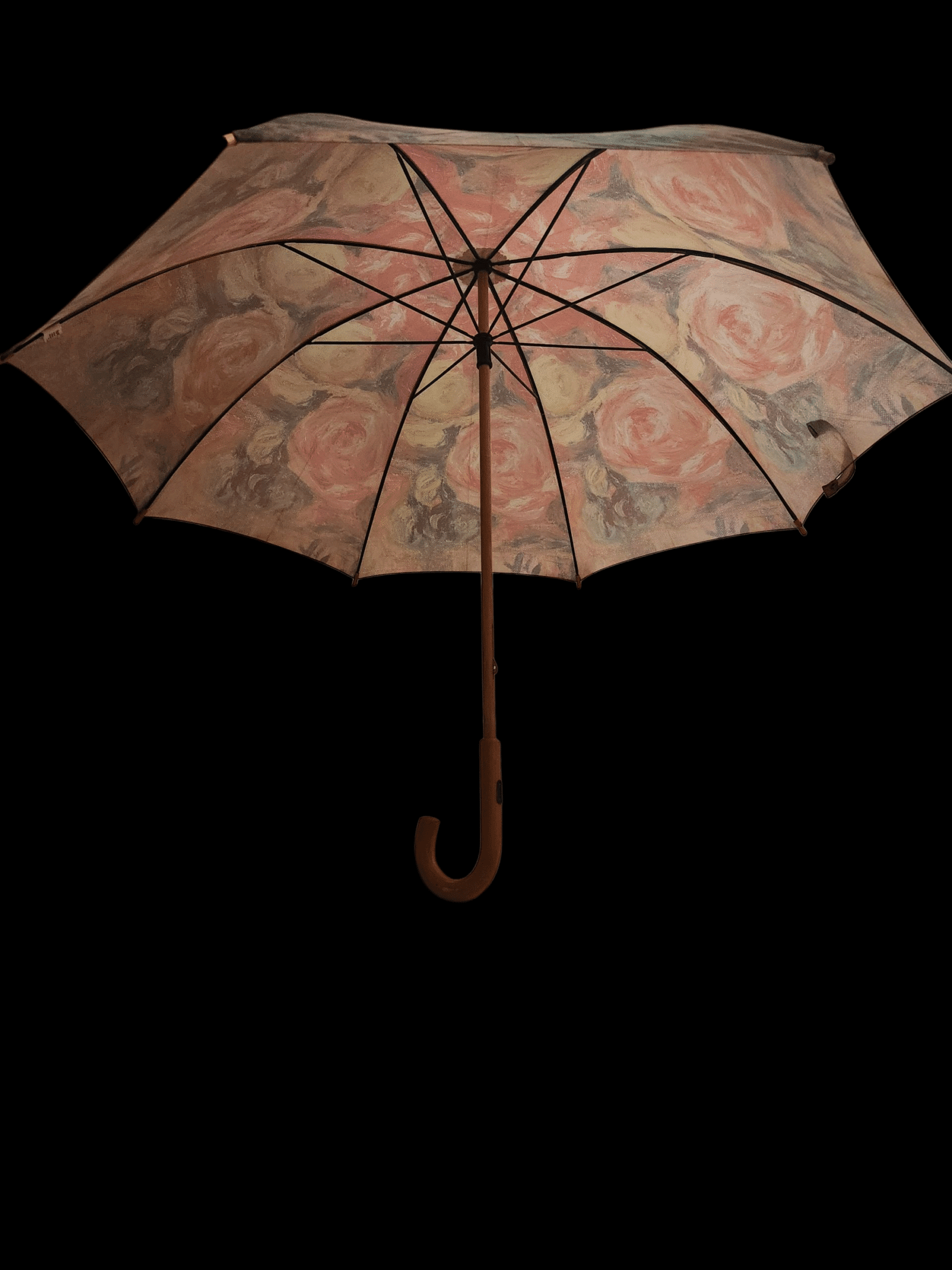 Vintage floral umbrella with a curved wooden handle.