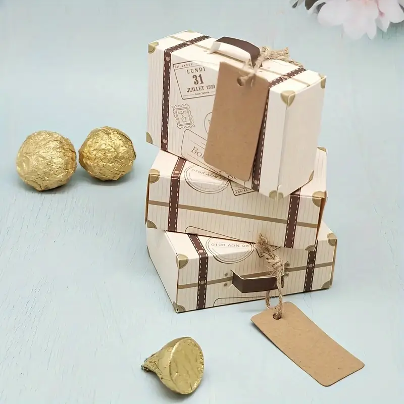 Two gift-wrapped boxes with ribbons and gold-wrapped chocolates.