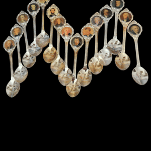 Spoons filled with various spices arranged in a zigzag pattern on a black background.