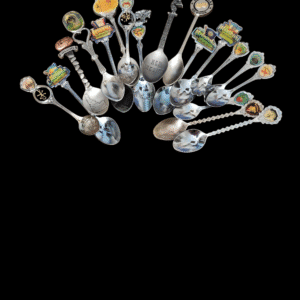 A collection of decorative souvenir spoons arranged in a semicircle on black.