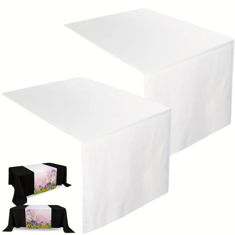 Two white paper table runners with black napkins and pink floral napkin rings.