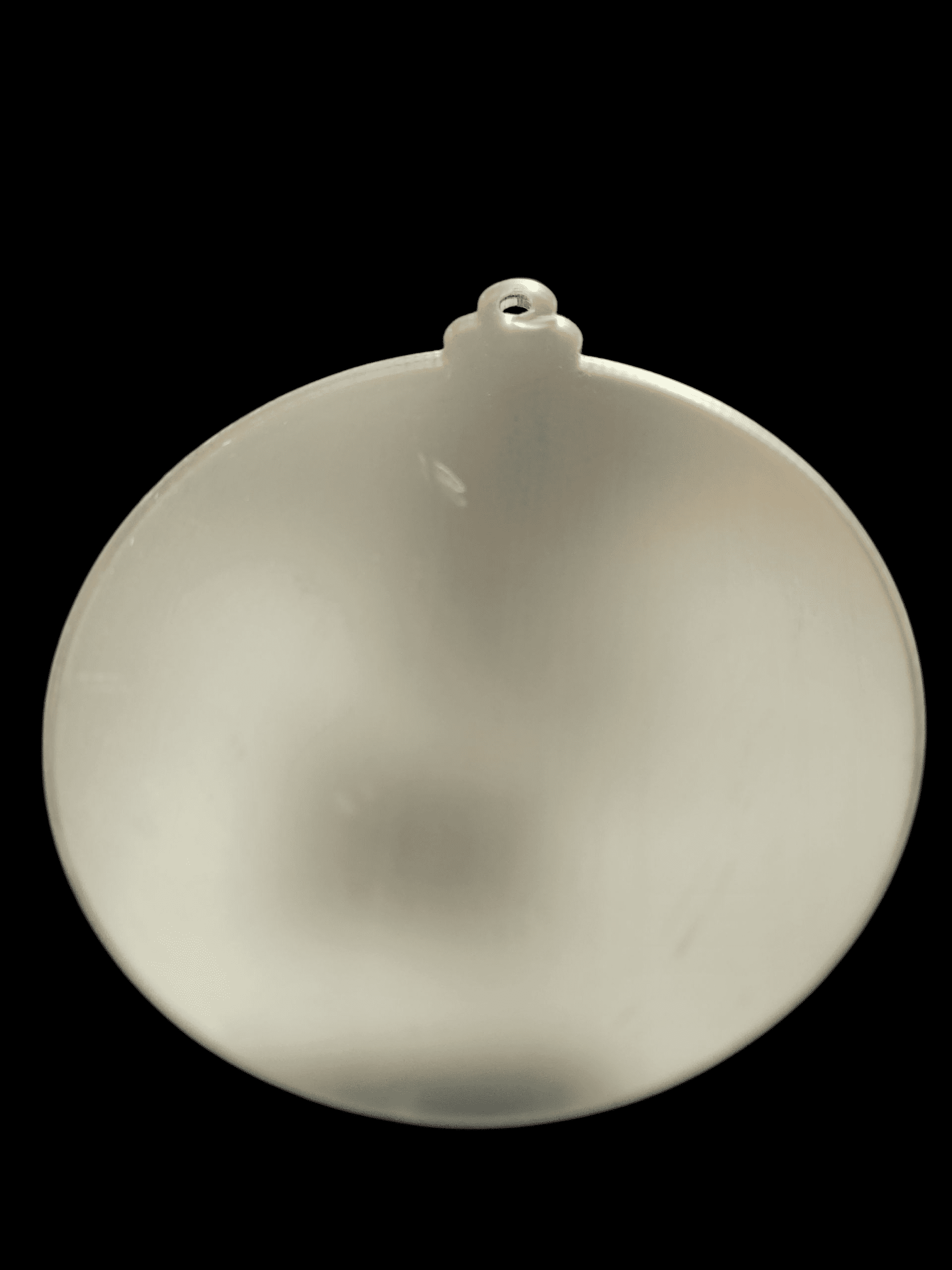 A frosted glass Christmas ornament with a small loop for hanging.