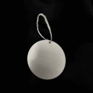 White circular tag with string on black background.